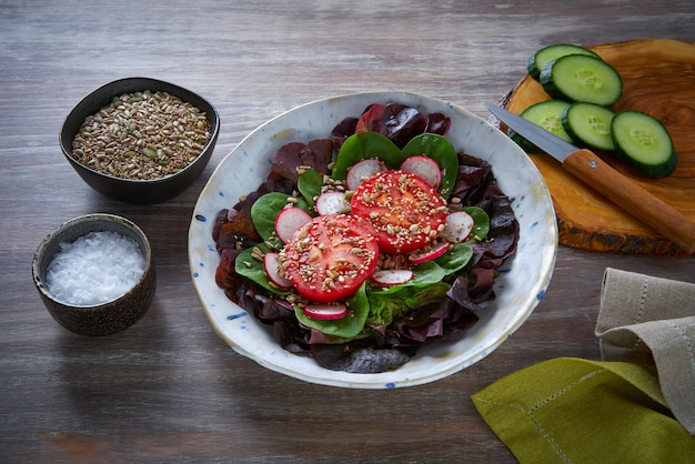 Tomato salad with seeds radish spinach lettuce