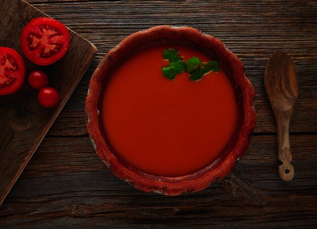 Tomato sauce on clay dish and dark wood