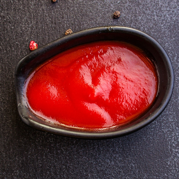 tomato sauce in a gravy boat on the table