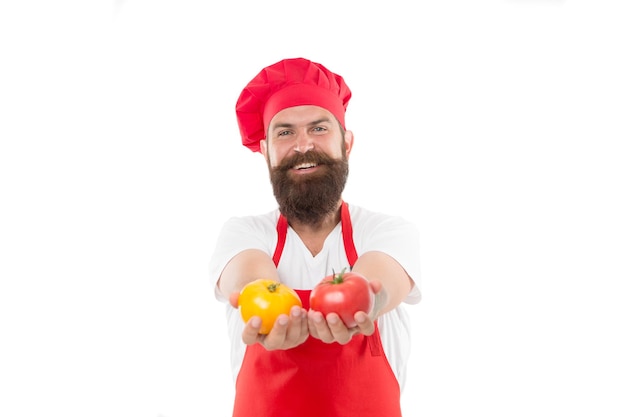 Tomato sauce recipe. Ripe tomato for delicious meal. Eat fresh tomato. Pick one. Healthy cooking concept. Man with beard on white background. Chef holds tomatoes. Cook in uniform holds vegetables.