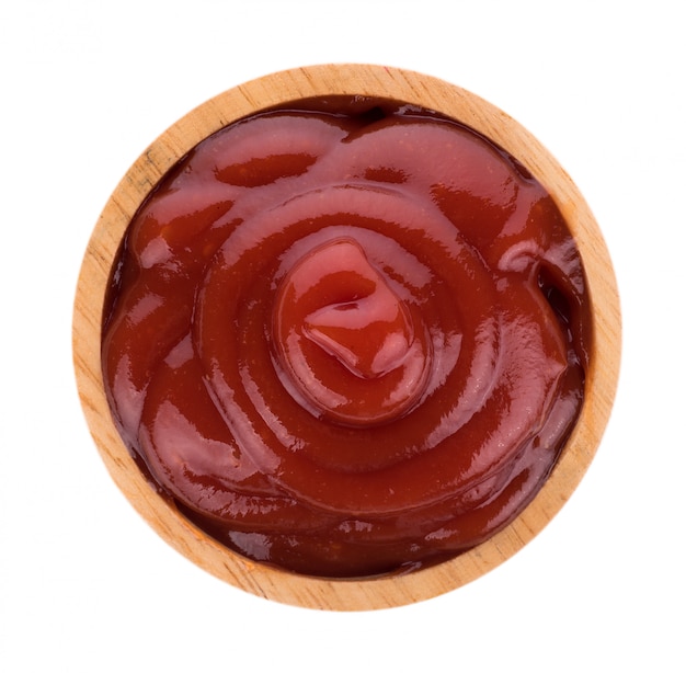 Tomato sauce in wooden bowl isolated