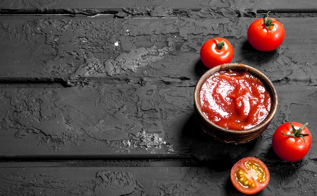 Tomato sauce in wooden bowl