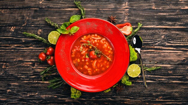 Tomato soup of corn chicken and chili pepper Top view On a black wooden background Copy space