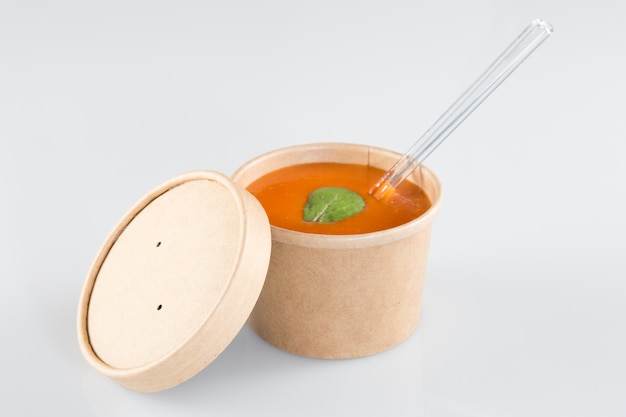 Tomato soup gazpacho on carton box takeaway