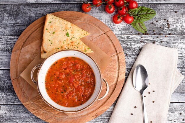 Tomato soup tomato soup on a white wooden background top view