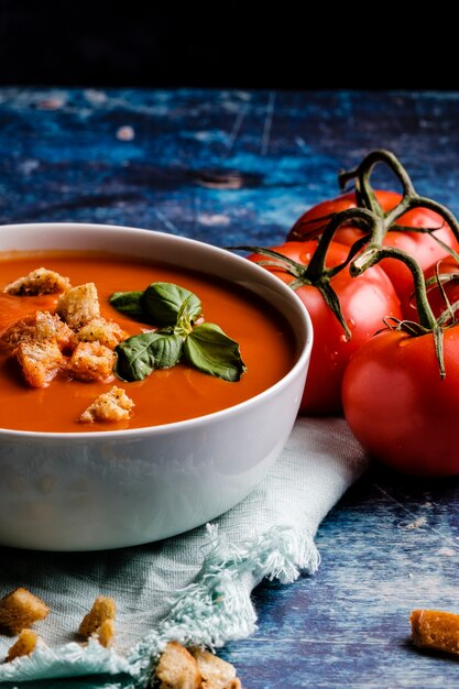 Tomato soup with basil in a bowl