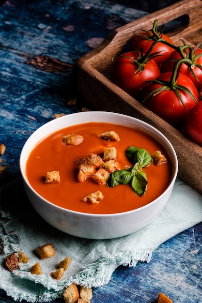 Tomato soup with basil in a bowl