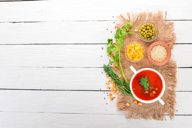 Tomato soup with chili and vegetables Healthy food On a white wooden background Top view Copy space for your text