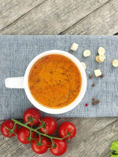 Tomato soup with fresh ingredients in a soup cup