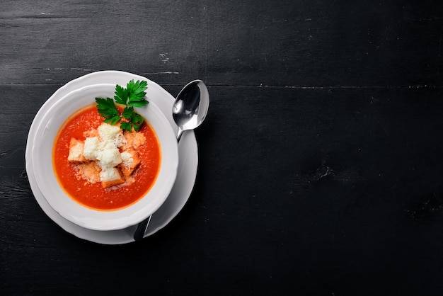 Tomato soup On a wooden surface Top view Free space for your text