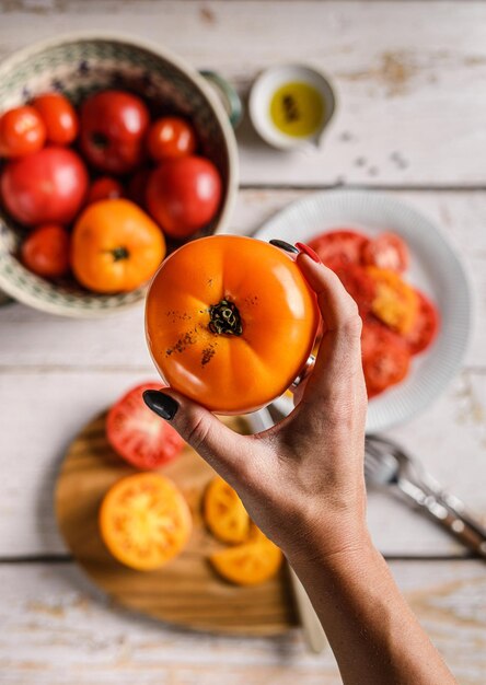 Tomatoes are yellow and red on a light background