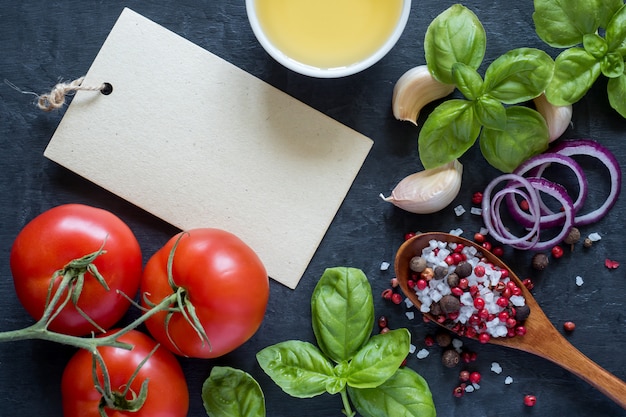 Tomatoes Basil Garlic and spices on a stone table