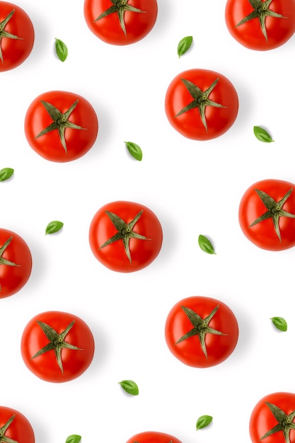 Photo tomatoes and basil leaves vertical pattern isolated on white background