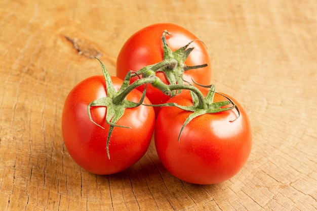 Tomatoes, beautiful tomatoes arranged over rustic wood, selective focus.