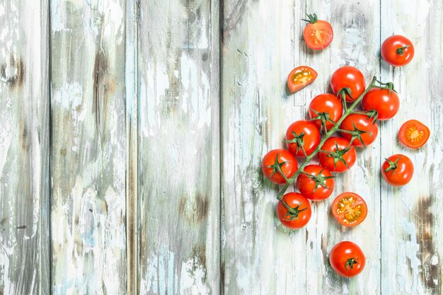 Tomatoes on a branch and pieces of fresh tomatoes