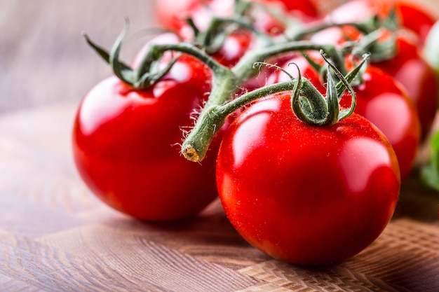 Tomatoes. Cherry tomatoes. Cocktail tomatoes on wooden board.