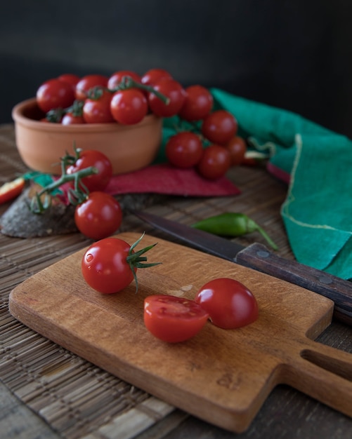 Tomatoes and chili pepper on a chopping board Chili peppers on a wooden chopping board