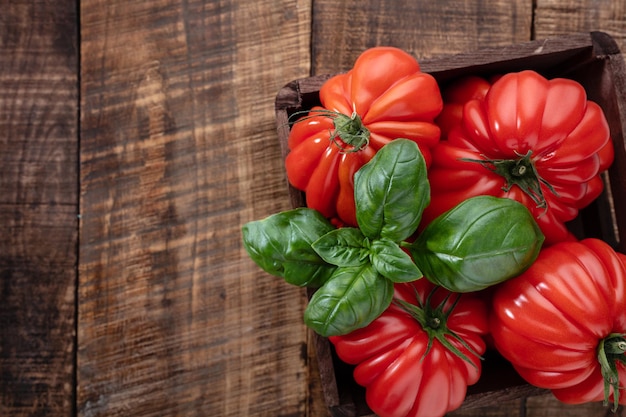 Tomatoes coeur with basil leaf,  close up.