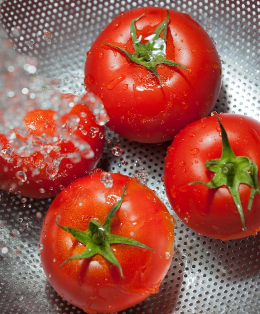 Tomatoes on a colander for cleaning