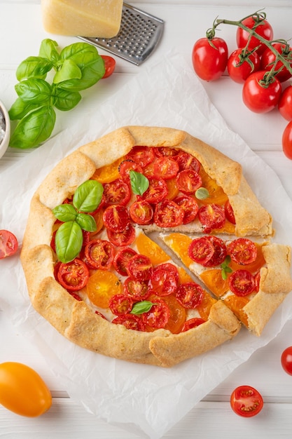 Tomatoes galette or pie with cheese and herbs Vegetarian dish Selective focus