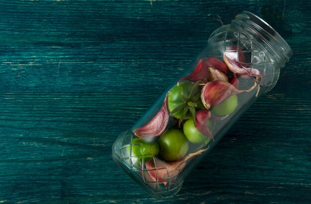 Tomatoes, garlic on a wooden surface.