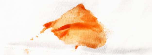 Tomatoes and ketchup stain on white shirt clothes close up banner