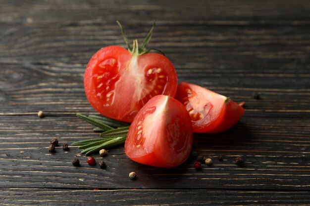 Tomatoes, pepper and rosemary on wooden table, close up