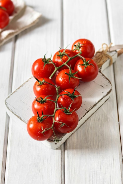 Tomatoes on a platter with a sprig of garlic