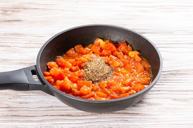 Tomatoes and spices in a pan. Chicken kadhai