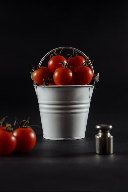 Tomatoes tomatoes in a glass tomatoes on scales wet tomatoes tomatoes on wooden background