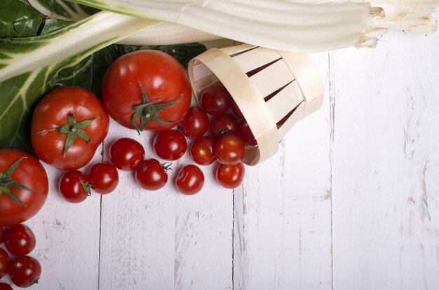 Tomatoes on white wooden eves