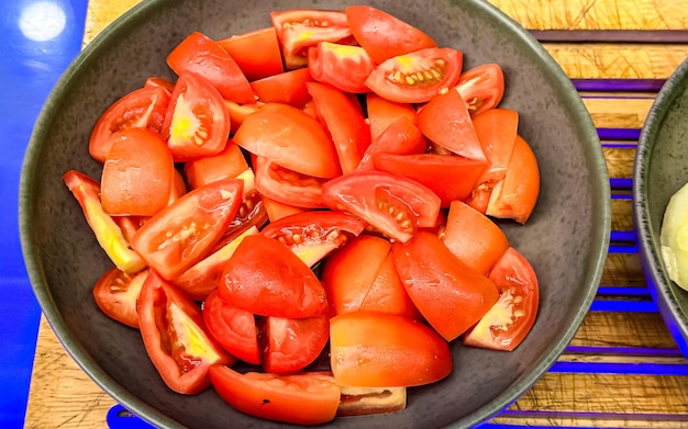Tomatoes in a wooden bowl on the counter of the market