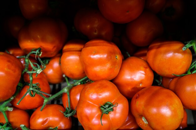 Tomatoes in a wooden box, market. Farm eco products.