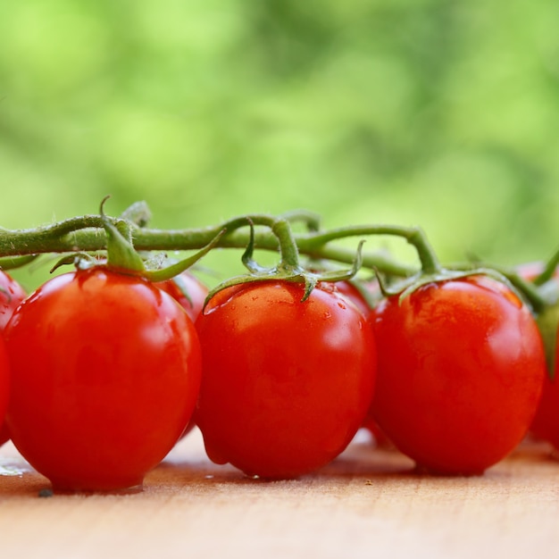 Tomatoes on the wooden table background with copyspace