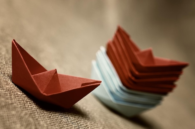 Toned colored paper boats glass