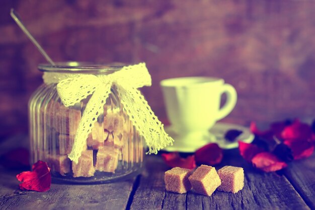 toned photo tea cup with sugar cubes