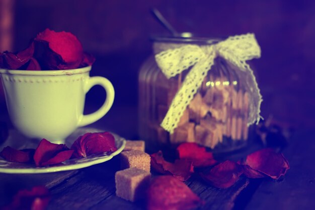 Toned photo tea cup with sugar cubes