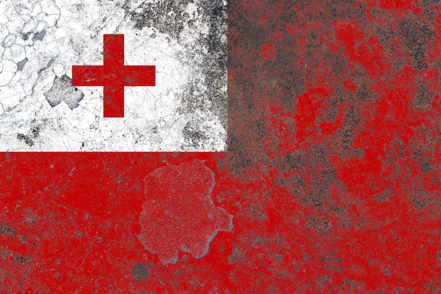 Tonga flag on a damaged old concrete wall surface