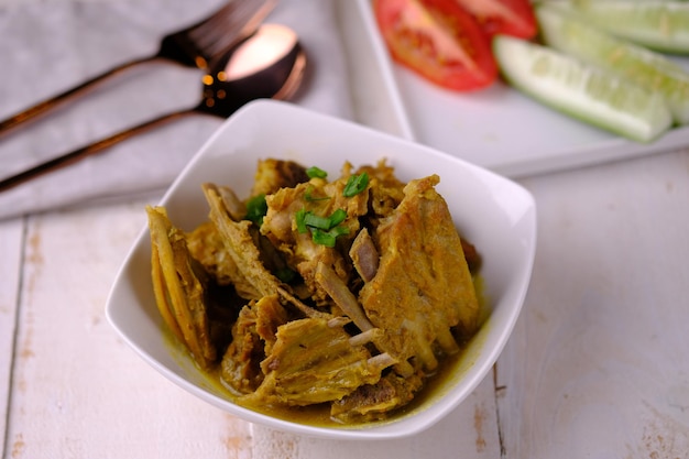 tongseng kambing is goat ribs cooked with soy sauce, coconut milk and spices. Indonesian food.