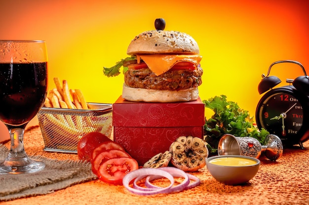 Tongue Twister Beef Naga burger with fries and tomato slice isolated on wooden board side view of american street food
