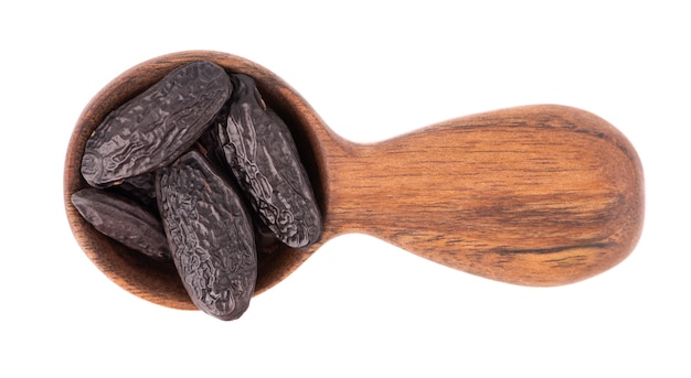 Tonka beans in wooden spoon