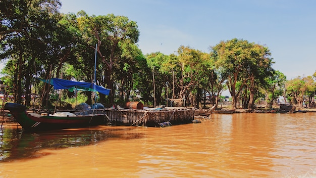 Tonle Sap lake. Kampong Phluk floating fishing village during drought season. Houses on stilts, people and boats. Poor country. Life and work residents Cambodian on water, near Siem Reap, Cambodia