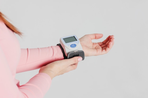 Tonometer device for measuring blood pressure on woman's hand on