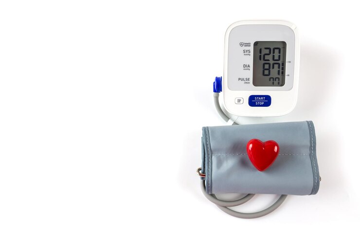Tonometer and red heart on a white background with copy space