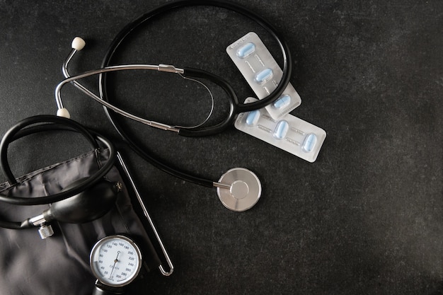 Tonometer with pills in a package on a gray surface