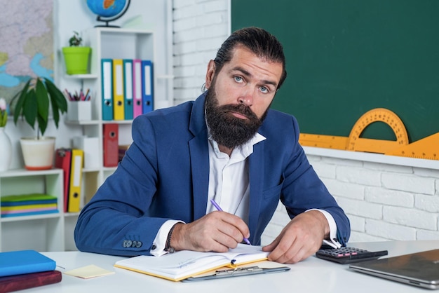 Too much work informal education male student sit in classroom while lesson pass the exam learning the subject back to school happy teachers day brutal man with beard wear costume