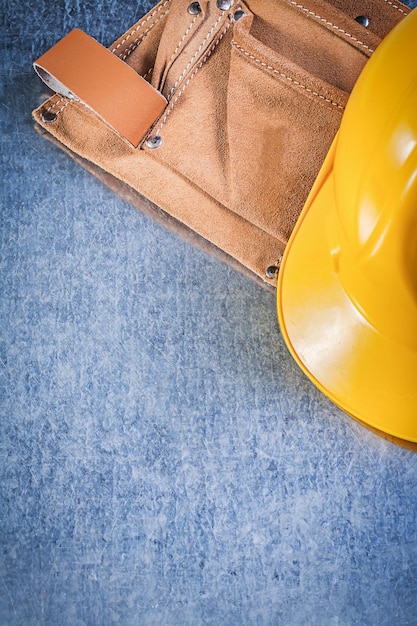 Tool belt safety building helmet on metallic background construction concept