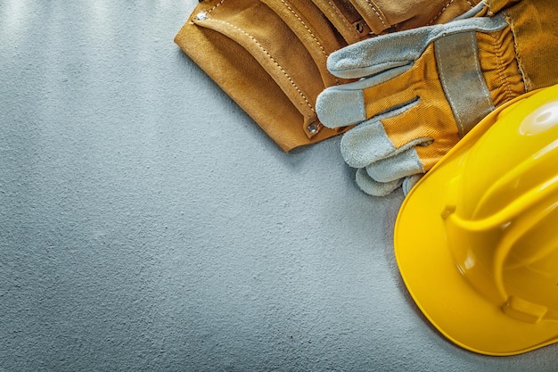 Tool belt safety gloves building helmet on concrete background