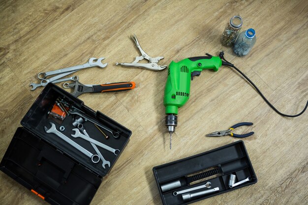 tool box and drill machine lying on floor