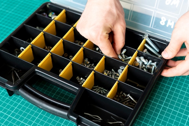 A Tool box with cells with screws, anchors, nails, bolts and other tools in workshop